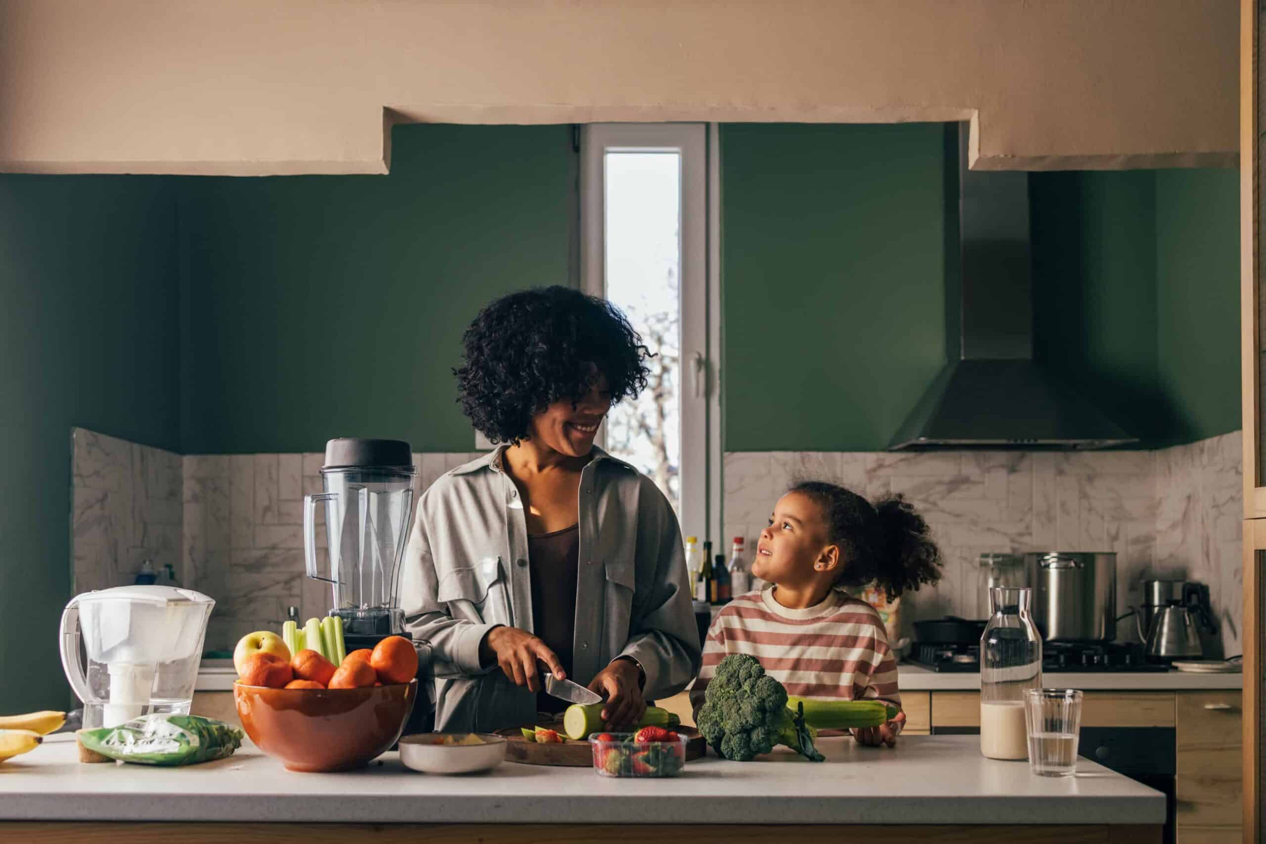 Mother and Daughter Preparing Healthy Food Together in Kitchen