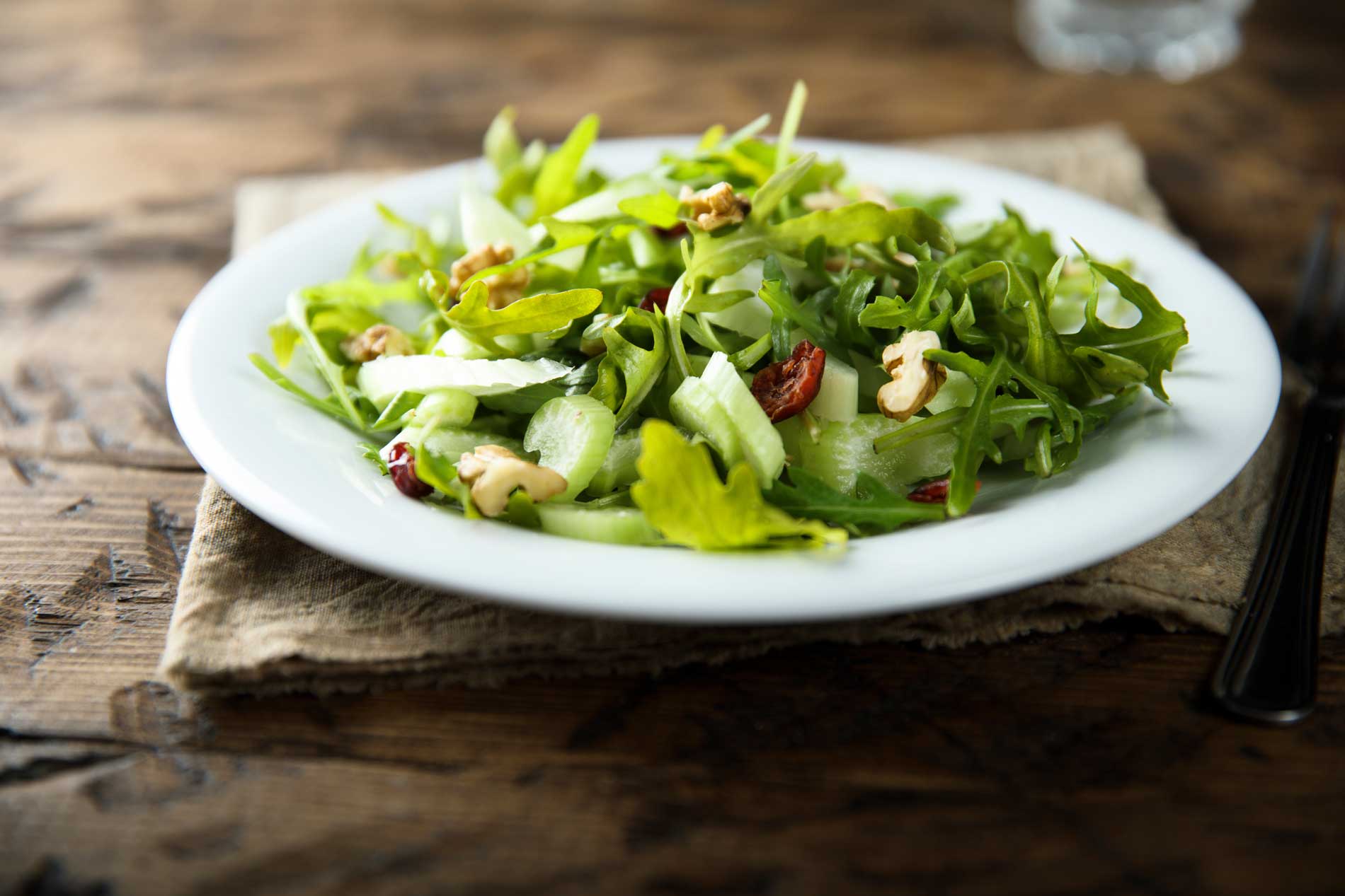 Fresh green salad with walnuts and cranberries